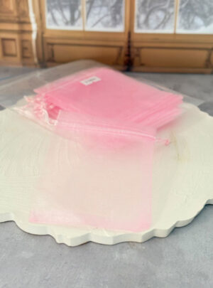 Añade un toque romántico, suave y encantador a tus entregas. Este set de bolsitas de organza en un hermoso tono rosado es la opción perfecta para recuerdos de eventos infantiles, baby showers, bautizos, San Valentín o líneas de cosmética delicada. Su tejido translúcido permite que tus productos se aprecien por completo mientras se mantienen protegidos con una presentación impecable.